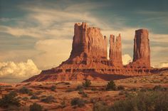 the large rock formations are towering over the desert