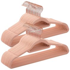 three pieces of pink plastic hair combs on top of each other in the shape of waves