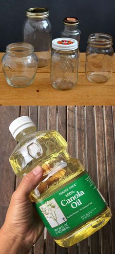 a hand holding a bottle of cooking oil next to jars filled with spices and herbs