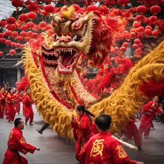 a group of people in red and yellow costumes dancing with dragon heads on their head