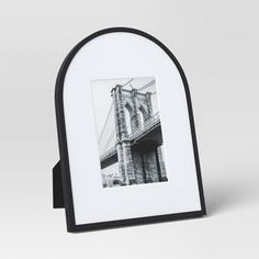 a black and white photo frame with an image of the brooklyn bridge on it's side