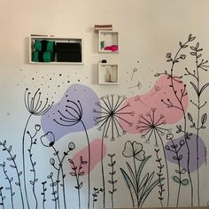 the wall is painted with flowers and plants