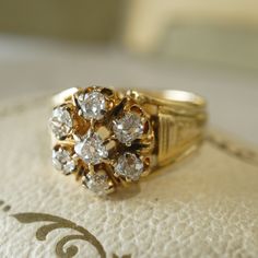 a gold ring with three diamonds on it sitting on top of a white paper towel