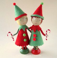 two small figurines holding hands with candy canes