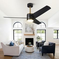 a living room with two couches and a ceiling fan