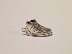 Women's & Men's Fashion 925 Sterling Silver, Old School Sneaker Shoe Design Necklace, Jewelry, Bling Description: This item is an amazing silver representation of a Old School Sneaker Shoe, with striking details. We simply call it Sneakers!   It's 100% Brand new and unique in its kind  If you are looking for a unique, stylish and high quality piece of jewelry then this item is perfect for you!  Jewelry is this one little thing that can make you feel unique. Color:Silver Material : 925 Sterling Silver Dimensions (cm): Height 1.8 x length 3 x width 1  Buy with confidence and own some precious metal!   Package Content: 1 x 925 Sterling Silver Old School Sneaker Shoe design necklace 1 x waxed cord  About Us  All of our silver Jewelry are designed and manufactured in our privately owned worksho It Sneakers, Jewelry Safe, Street Culture, Shoe Design, Christmas Gift Jewelry, Modern Gift, Sterling Silver Necklace Pendants, Silver Pendant Necklace, Chains Jewelry