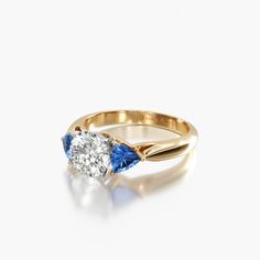 a diamond and blue sapphire engagement ring