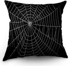 a black and white spiderweave pillow on a white background, with the web in it's center