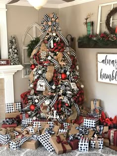 a christmas tree decorated with black and white plaid ribbon