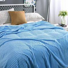 a bed with a blue blanket on top of it