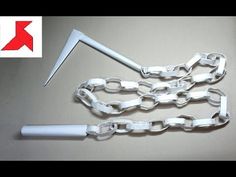 an image of a chain with a knife stuck in the middle and some chains attached to it