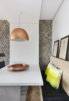 a white table with a gold plate on it in a room that looks like a modern home