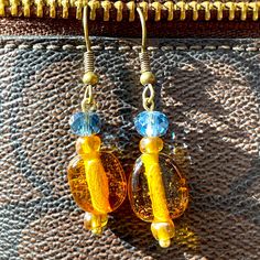 Each Pair Has Unique Handmade Beads Title: Sun-Kissed Amber Earrings My Process: My Earrings Are Handmade From My Vintage Bead Collection. I Enjoy Creating Looks That Are Unique And Creative. Description: These Vibrant Earrings Capture The Warmth And Energy Of The Sun With Their Rich Amber Hue. The Shimmering Glass Beads And Gold-Tone Accents Create A Dazzling And Eye-Catching Effect. Perfect For Adding A Touch Of Sunshine To Your Wardrobe. Materials: Blue & Bronze Glass Beads Amber Colored Glas Blue Amber Jewelry, Teen Accessories, Bead Collection, Glass Drop Earrings, Amber Color, Lampwork Glass Beads