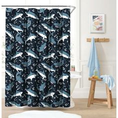 a bathroom with a shower curtain that has dolphins on it and stars in the sky