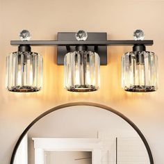 a bathroom vanity light with two lights on each side and a mirror in the middle