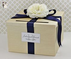 a box with a flower on it and ribbon around the lid is shown in this image