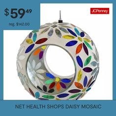 a glass ornament with colorful leaves on it and the words net health shops daisy mosaic