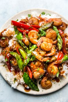 a white plate topped with shrimp and veggies