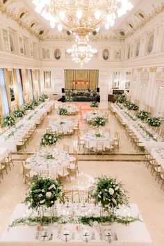 an elegant banquet hall with tables and chairs