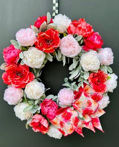 a wreath with red and white flowers on it