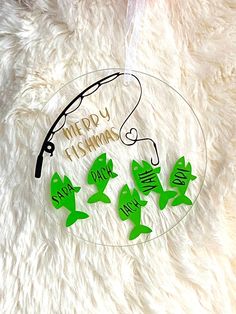 a glass plate with some green fish on it and the words happy fishing are written in cursive writing