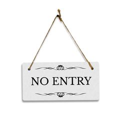 a sign that says no entry hanging from a rope on a white wall with black lettering