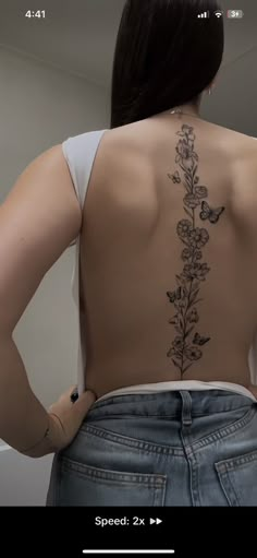 the back of a woman's body with flowers on it