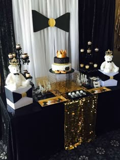 a black and gold dessert table with teddy bears