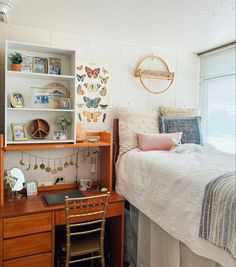 a bed room with a neatly made bed and a desk