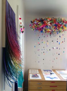 the room is decorated with colorful streamers hanging from the ceiling and on the wall