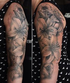 a woman's arm with flowers and birds on it