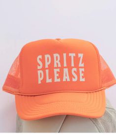 an orange hat with the words spirit please on it