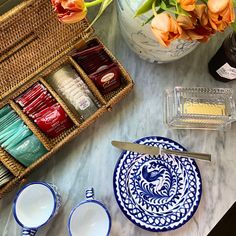 the table is covered with dishes and vases