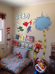 a child's bedroom with dr seuss and the cat in the hat wall decals