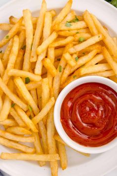 french fries and ketchup on a white plate