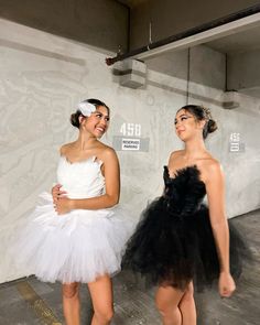 two young women dressed in tulle and garb, standing next to each other