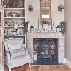 a living room filled with furniture and a fire place in front of a brick fireplace