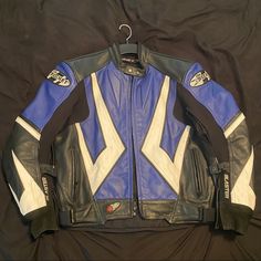 a blue and white leather jacket on a black background