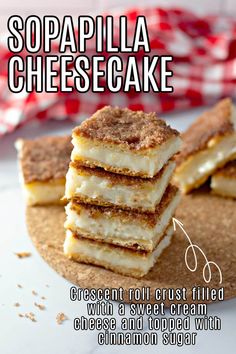 a stack of cheesecakes sitting on top of a white plate next to a red and white checkered napkin