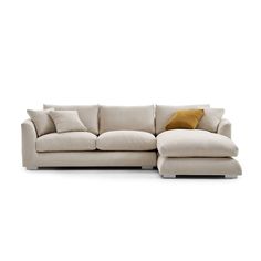 a white couch with pillows on it and a pillow in the middle of the couch