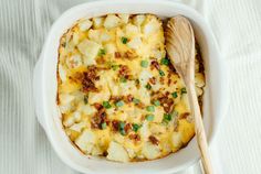 a casserole dish with potatoes and green onions