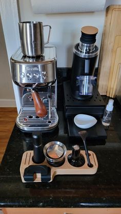 there is a coffee maker on the counter next to other items that are being used for espresso