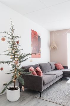 a living room filled with furniture and a christmas tree