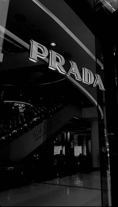 a black and white photo of a prada store