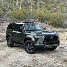 a black suv is parked in the desert