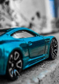 a blue toy car sitting on the ground