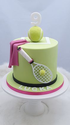 there is a cake that has a tennis racket and ball on top of it