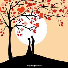 a couple standing under a tree with hearts on it