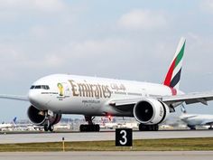 an airplane on the runway with other planes in the background