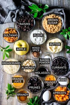 the ingredients for an apple pie laid out in bowls on a wooden table with green leaves